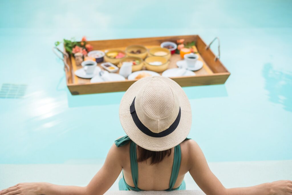 woman-having-floating-breakfast-in-luxury-pool-hotel-girl-with-hat-enjoy-in-tropical-resort.jpg
